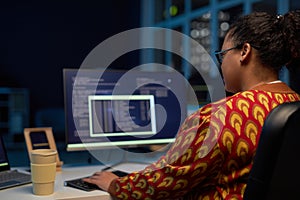 Female programmer working with computer codes