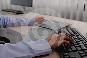 Female programmer working on a computer planning a program in an office. Notebook and troubleshooting program