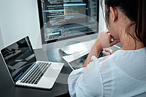 Female Programmer working in software javascript computer in IT office, Writing codes and data code website and coding database