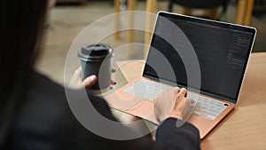 Female programmer working on web site project, programming on desktop computer in startup company