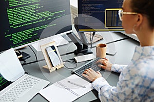 Female programmer writing codes to software