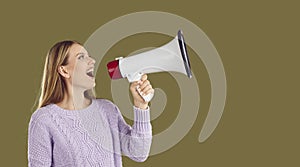 Female promoter announces through megaphone seasonal discounts attracting buyers.