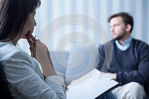 Female psychiatrist talking with patient