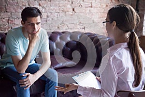 Female psychologist counselor talking to a client.