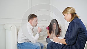 Female psychologist helping worried young couple.