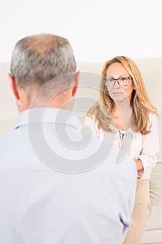 Female psychologist listening to elderly man