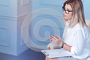 Female psychologist sitting on chair while working in office