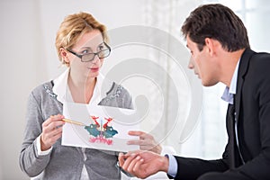 Female psychotherapist holding Rorschach Test