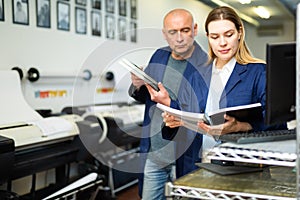 Woman printing office worker reading operation manual