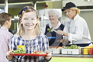 Female Pupil With Healthy Lunch In School Canteen photo