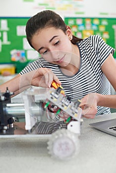 Female Pupil In Science Lesson Studying Robotics