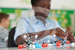 Female Pupil Using Molecular Model Kit In Science Lesson