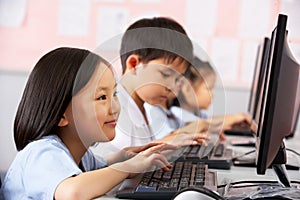 Female Pupil Using Keyboard During Computer Class