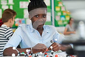 Female Pupil Using Molecular Model Kit In Science Lesson