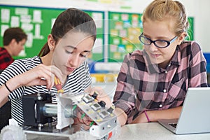 Female Pupils In Science Lesson Studying Robotics