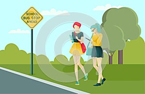 Female Pupils Waiting Transport at School Bus Stop