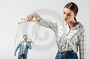 Female puppeteer holding male marionette with