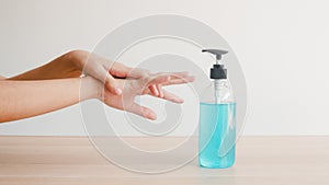 Female push alcohol bottle to clean hand for hygiene when social distancing stay at home and self quarantine time.