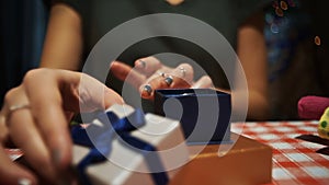 Female putting a silver ring into a small blue secret present box