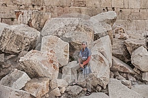 Tourist Posing on the Fallen Stones of the Second Temple in Jerusalem