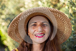 Female with radiant smile wearing straw hat