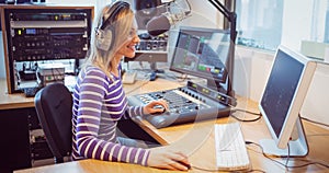 Female radio host broadcasting through microphone