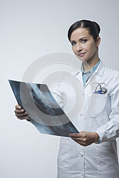 Female radiologist checking x-ray image