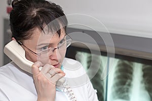 Female radiologist doctor talking on a phone