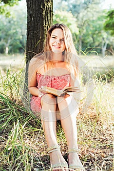 Female reading book in park