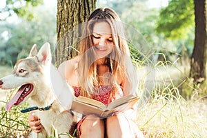 Female reading book in park