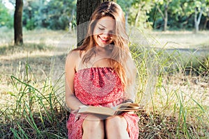 Female reading book in park