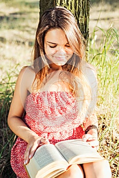 Female reading book in park