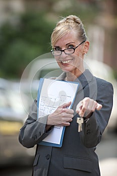 Female Real Estate Agent holding house key