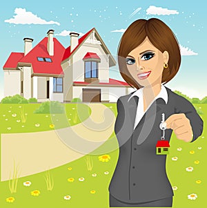 Female real estate agent holding the key of a new house