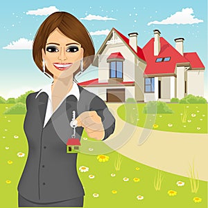 Female real estate agent holding the key of a new house
