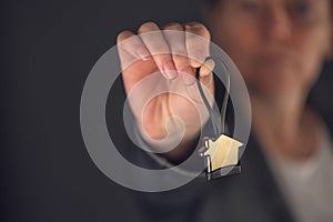 Female real estate agent with house model key ring