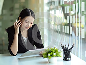 Female real estate agent reading the informations on tablet computer