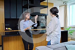 Female real estate agent showing apartment, house, to buyer, tenant