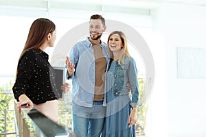 Female real estate agent showing new house to couple