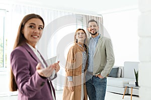 Female real estate agent showing new house to couple