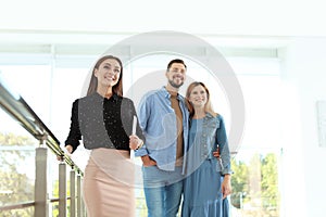 Female real estate agent showing new house to couple