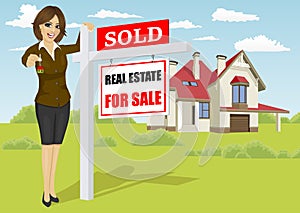 Female real estate agent standing next to sold for sale sign in front of classic cottage