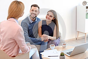 Female real estate agent working with couple