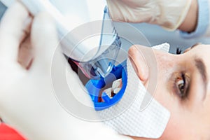 Female receiving teeth whitening procedure