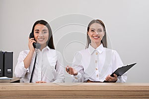 Female receptionists working at desk in hotel