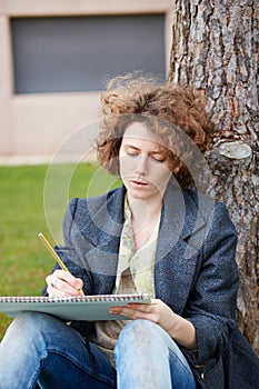Female redhead art student drawing outdoors