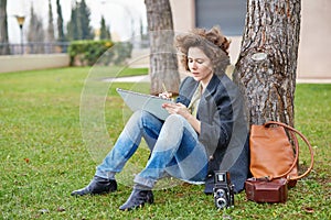 Female redhead art student drawing outdoors