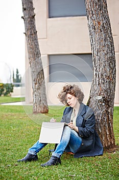 Female redhead art student drawing outdoors