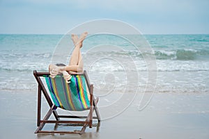 Female relaxing on beach chair