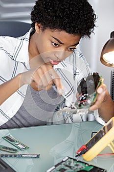 female repairwoman disassembling smartphone with screwdriver